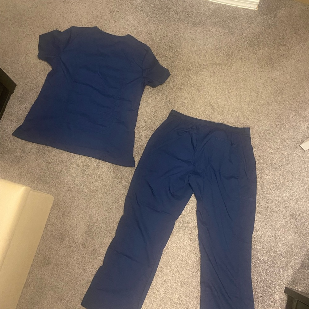 Dark navy blue color. Top is size medium and pants are medium petite.